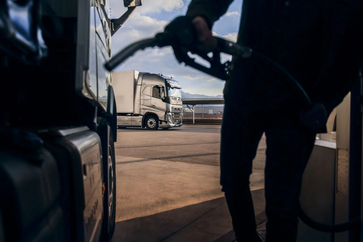 Imposto federal PIS/COFINS sobre o diesel aumenta nesta terça-feira (5/9). Na imagem: Foto à contraluz de frentista abastecendo caminhão com óleo diesel (Foto: Divulgação Volvo)